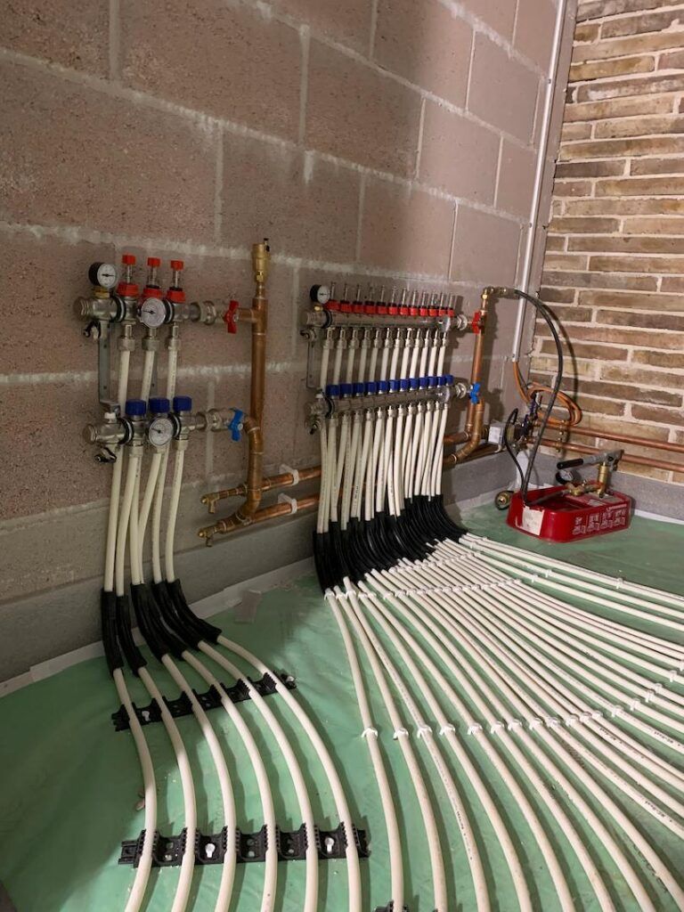 Underfloor heating pipes at wall